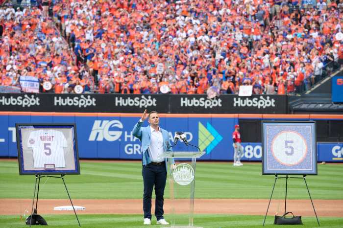 David Wright: Man in blue suit stands on baseball field and gives speech to fans.