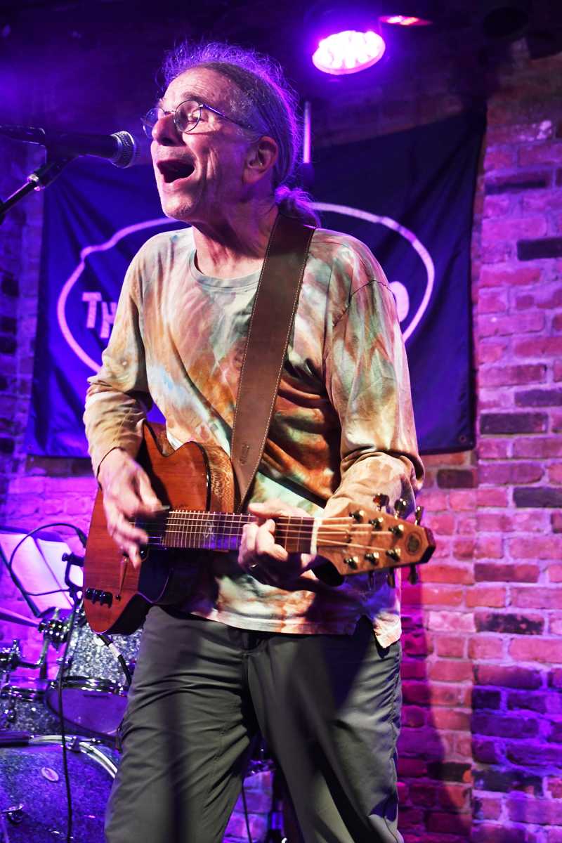 Man playing guitar and singing on stage