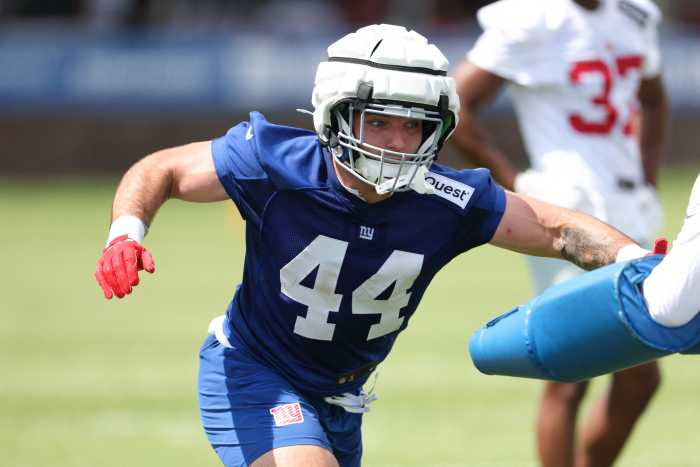giants player in white and blue uniform running route in training camp