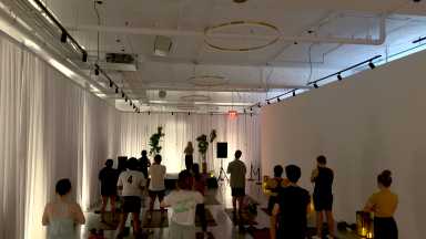 People in a yoga class standing