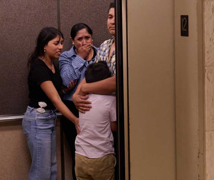 ICE in courts: More immigrants cuffed at Federal Plaza as even officers feel the strain 3 four people, one a young boy, inside an elevator appearing upset