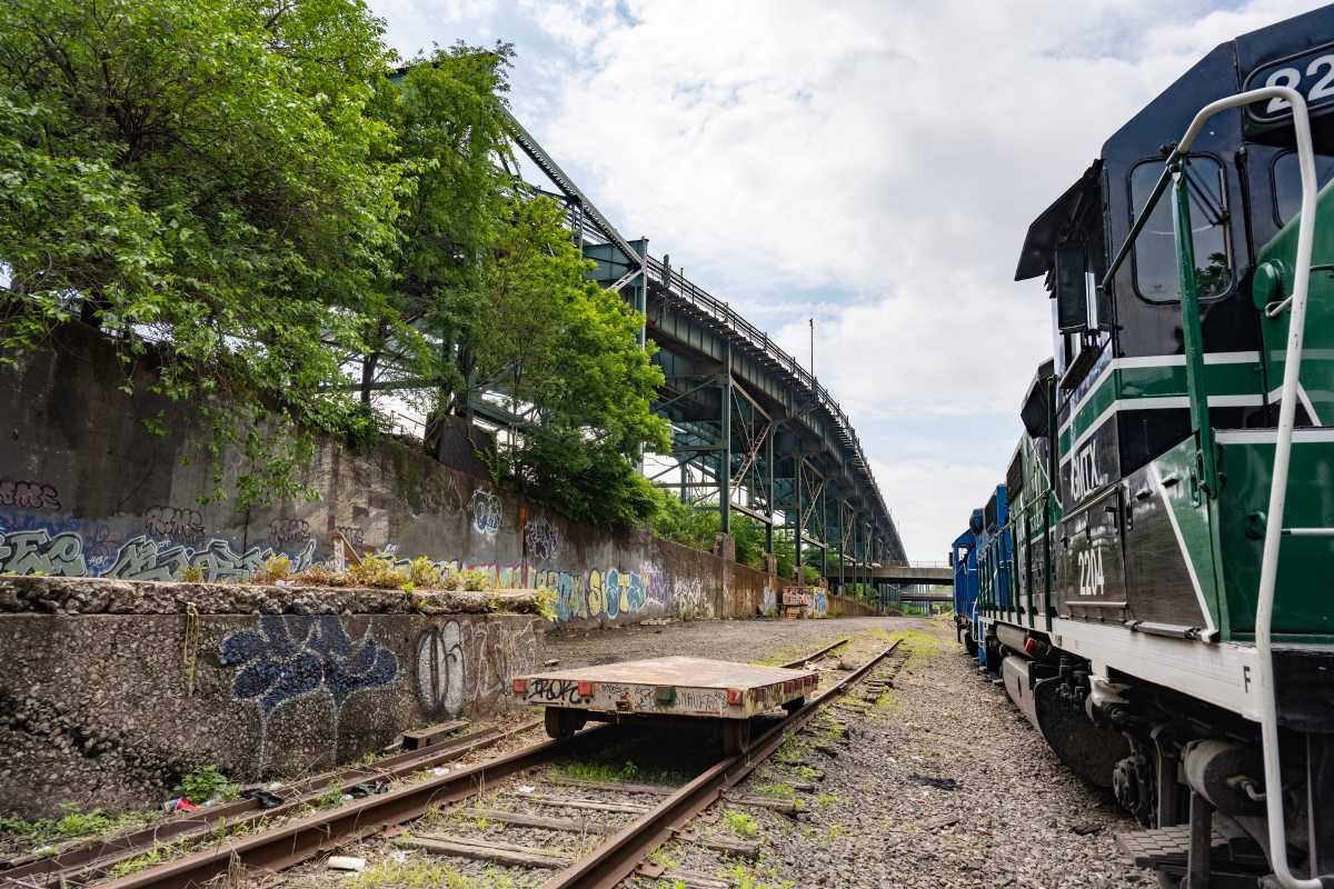 Interborough Express: The new IBX light rail line from Queens to Brooklyn is now one step closer to a reality 2 railroad tracks and locomotive near trees on the IBX line