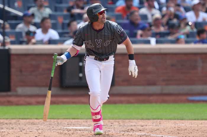 Jeff McNeil Mets: Man in grey baseball uniform drops bat after hitting a single.