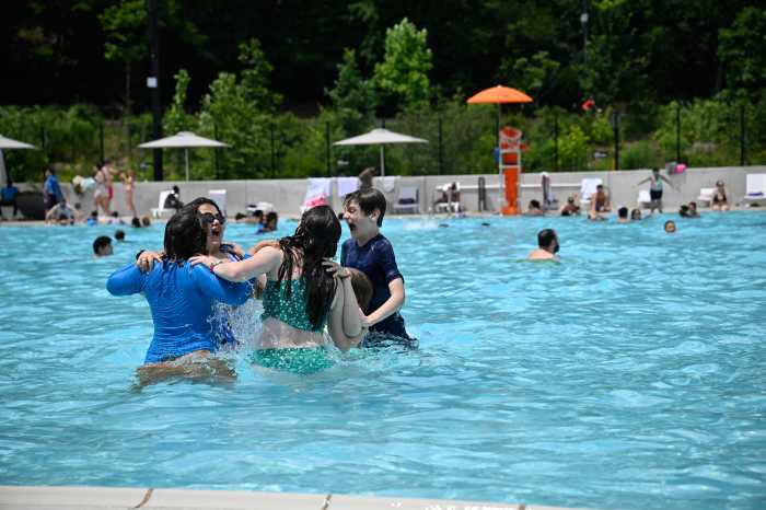 people swimming in a large outdoor pool