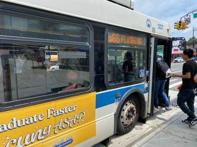 people boarding a NYC bus during the day