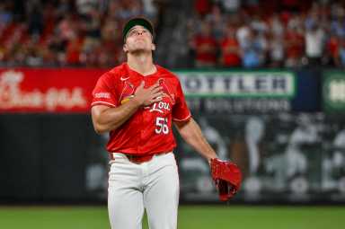 Ryan Helsley Mets trade: Baseball pitcher in red uniform looks up to sky after recording third out