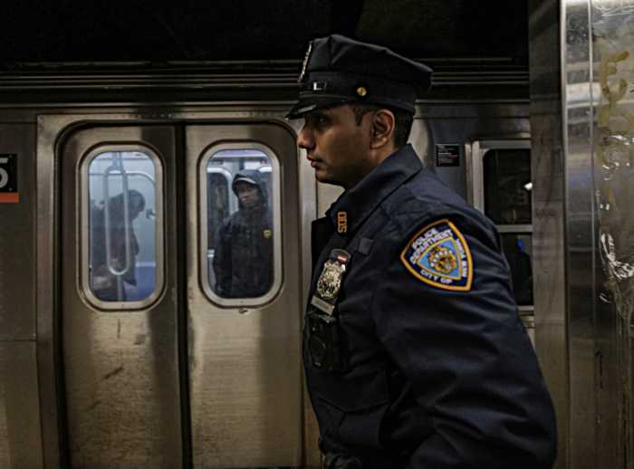 cop on a subway platform