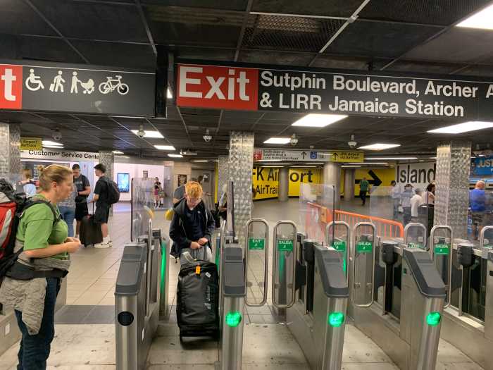 15 new MTA customer service centers to open in subway stations throughout NYC 2 many people, some with luggage, going through turnstiles at a subway station