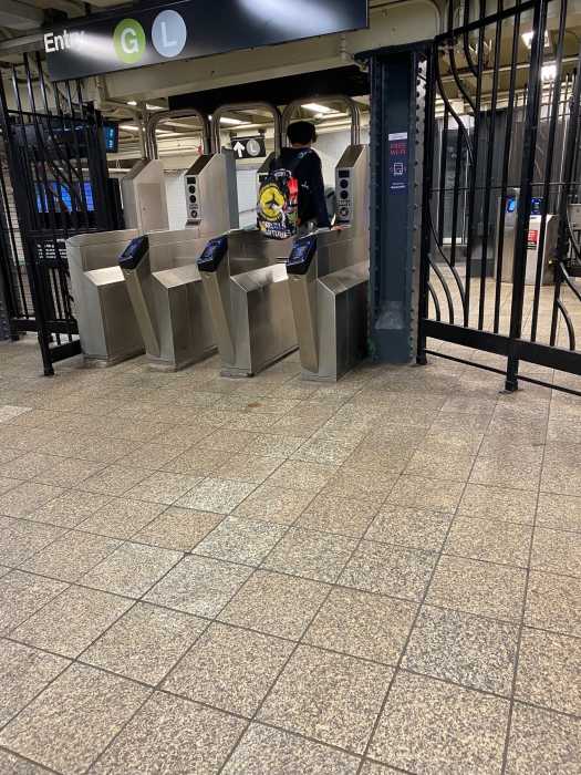 person wearing black jumps over a turnstile