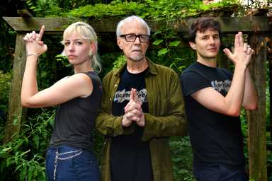 three people posing in garden like charlie's angels in East Village