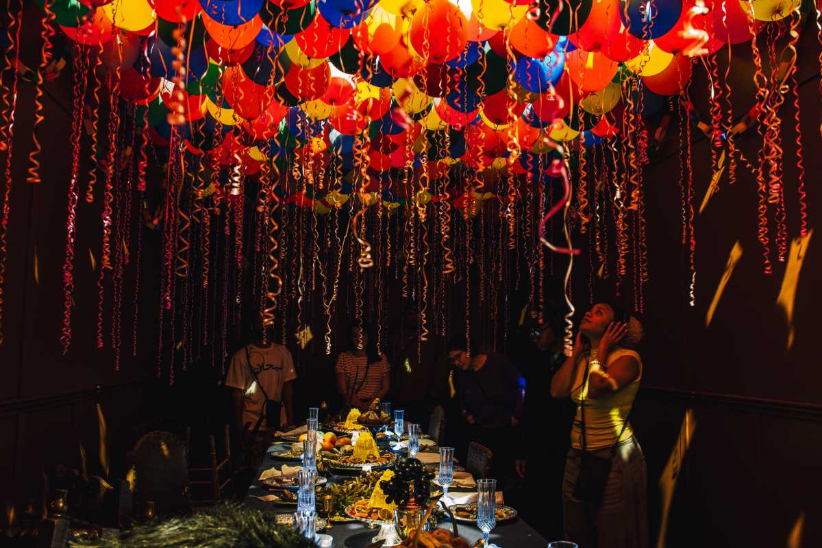 Review | ‘Viola’s Room’ featuring Helena Bonham Carter takes you on a moody, barefoot field trip 2 people stare at balloon field ceiling above dining room table in interactive broadway show viola's room