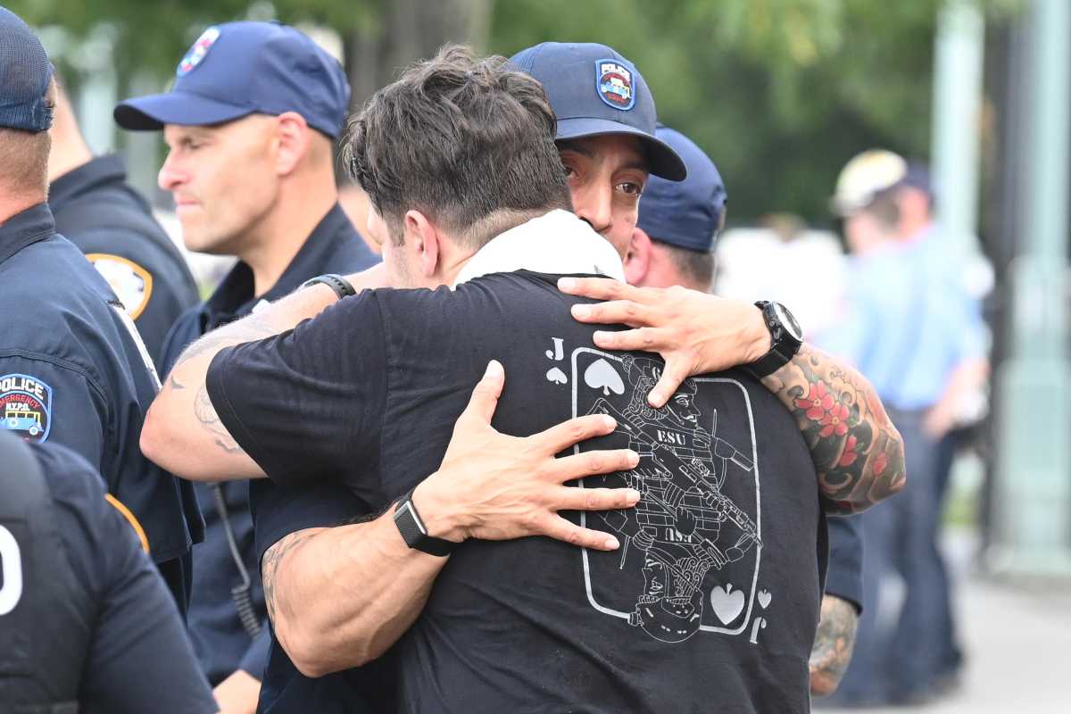 First responders embrace after rescuing person from Hudson River