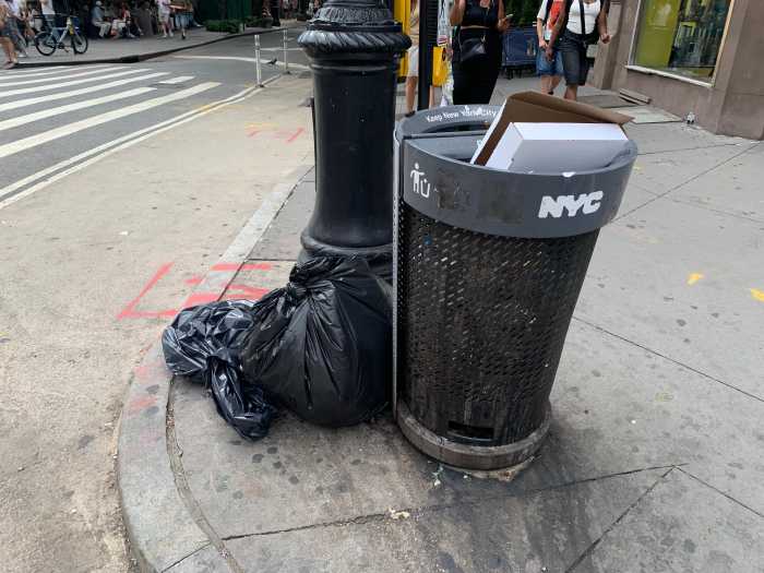 Trash talk: What's NYC doing about overflowing public litter baskets full of waste? 2 a public garbage can on a street corner
