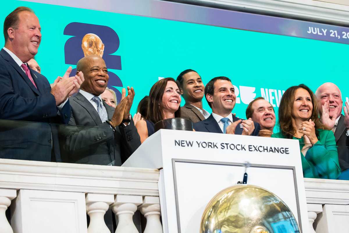 World Cup stock exchange: Group of officials and politicians in suits stand on ledge and clap