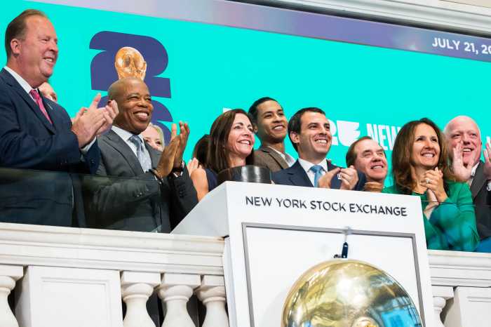 World Cup stock exchange: Group of officials and politicians in suits stand on ledge and clap