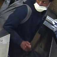 Man who slashed woman during robbery aboard Lower Manhattan train faces attempted murder charges 15 Man in white mask exiting subway turnstile after woman slashed
