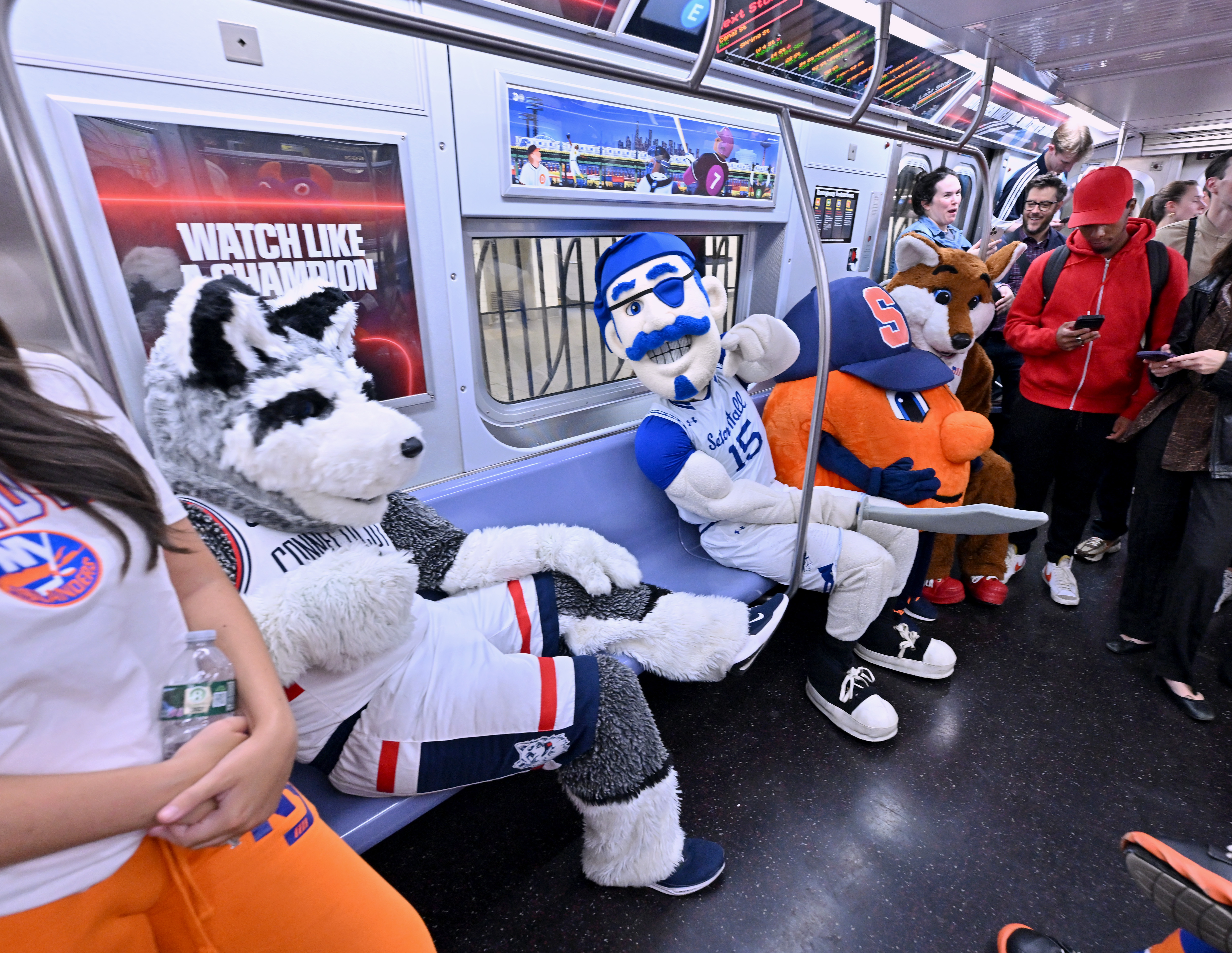 Commuters and notable tri-state area mascots  ride the ESPN "E" train celebrating the launch of the all-new ESPN app on August 21, 2025 in New York City. 