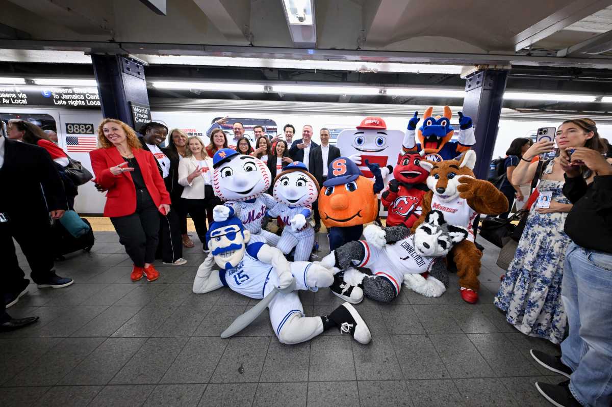 Jo Fox, Rosalyn Durant, Denise Pellegrini, Tina Thornton, Rita Ferro, Judy Agay, Jimmy Zasowski, Elle Duncan, Adam Smith, Chara-Lynn Aguiar, Burke Magnus, ESPN Chairman Jimmy Pitaro and notable tri-state area mascots take the inaugural ride of ESPN’s "E" train takeover celebrating the launch of the new ESPN app on August 21, 2025 in New York City.