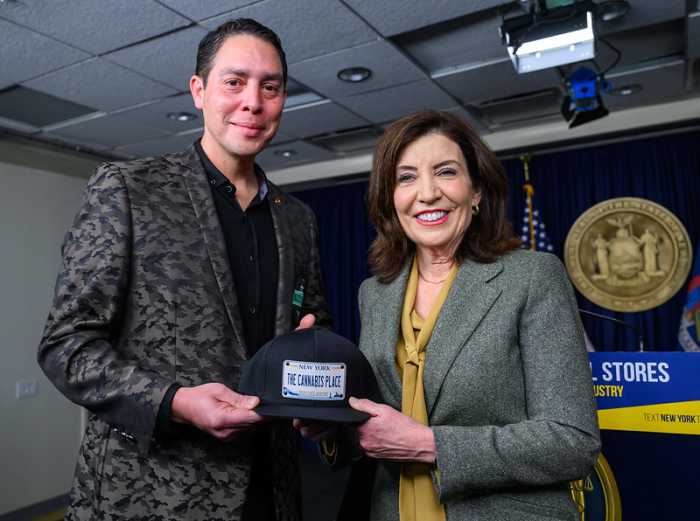 Osbert Orduna, CEO of The Cannabis Place, with New York Gov. Kathy Hochul at a Feb. 24 event announcing the state’s efforts to crack down on the illegal cannabis market. Hochul is not named as a defendant in the lawsuit challenging the state’s reinterpretation of its school-distance rule.