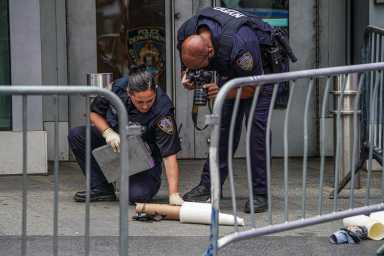 Police in Times Square examine suspicious package left behind near station.