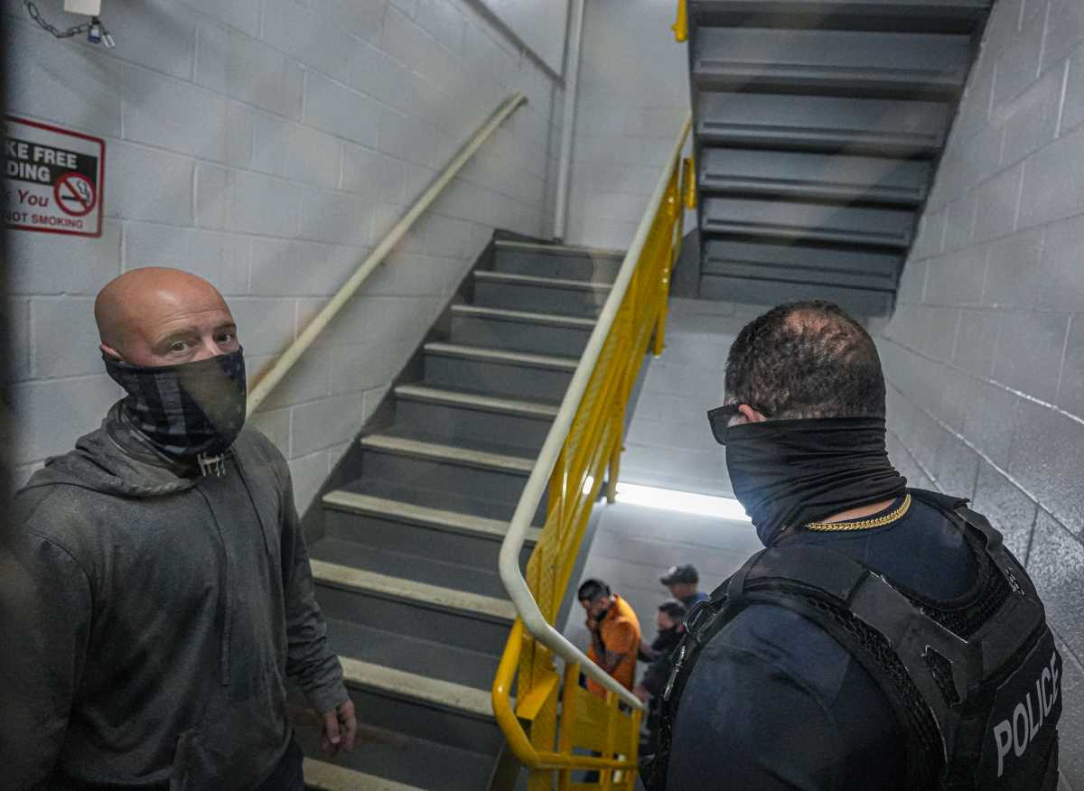ICE agents in hallway of Federal Plaza questioning man during arrest