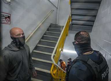 ICE agents in hallway of Federal Plaza questioning man during arrest
