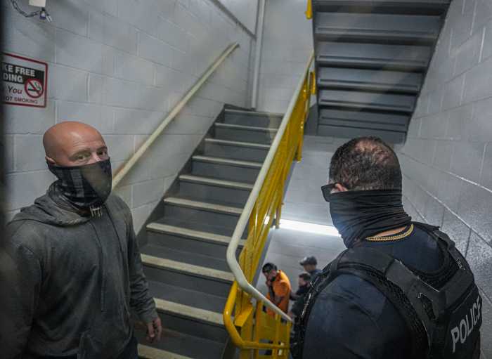 ICE agents in hallway of Federal Plaza questioning man during arrest