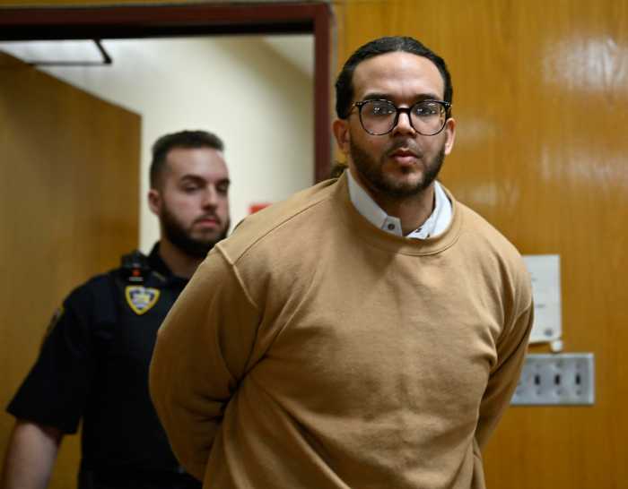 Convicted rapist of transgender woman in Manhattan walks in handcuffs.