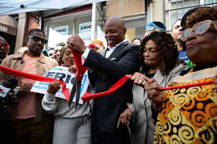 Mayor Eric Adams cuts the ribbon at his new Harlem campaign office at 102 West 124th Street on Wednesday
