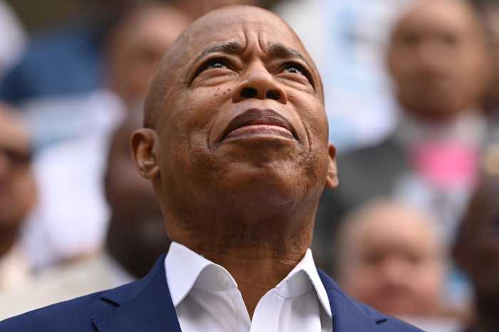 Mayor Eric Adams looks up at the sky