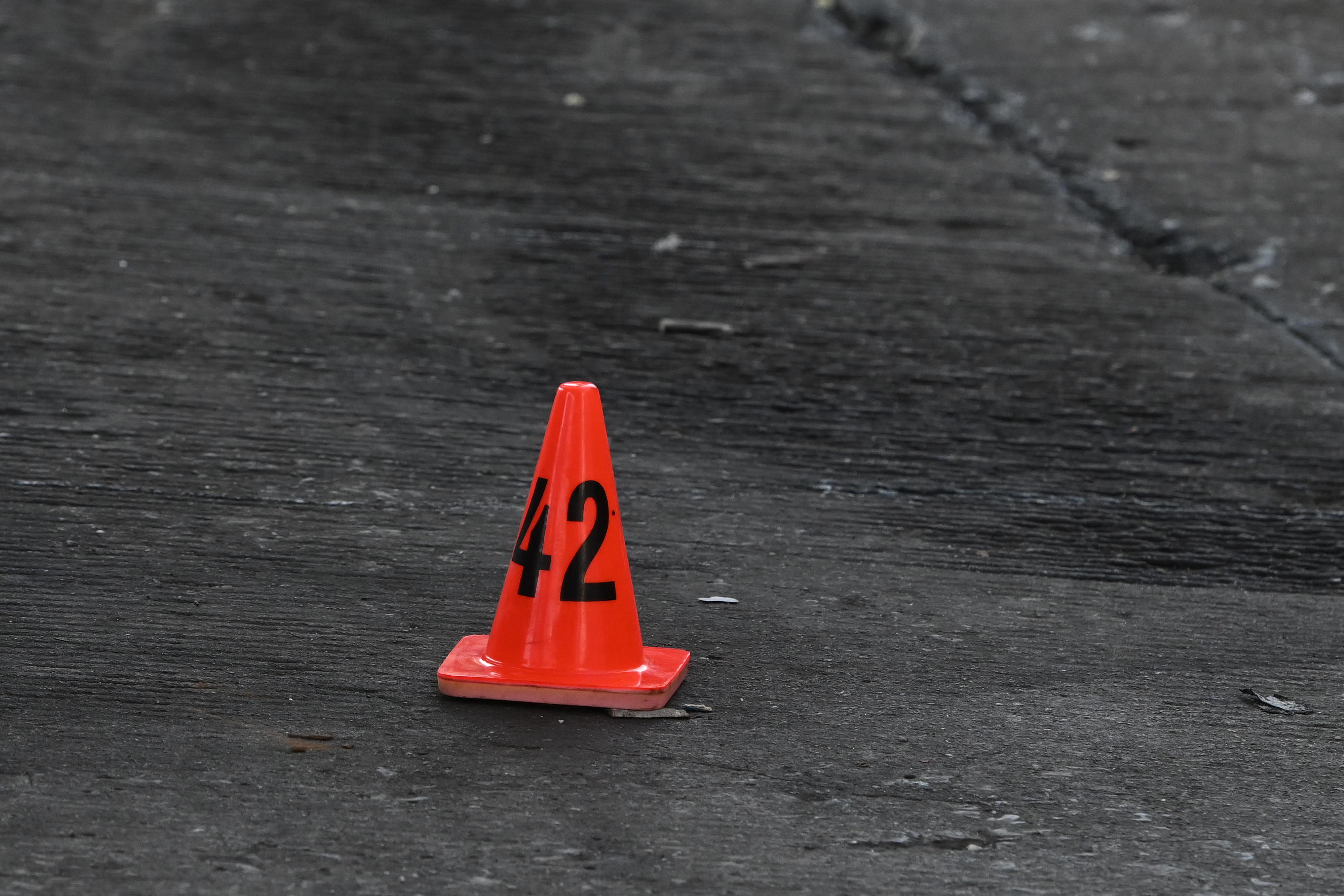 A shell casing lays on the ground under a cone following a shooting at Broadway and Kossuth Place. The victim was left in critical condition on Thursday, August 7..