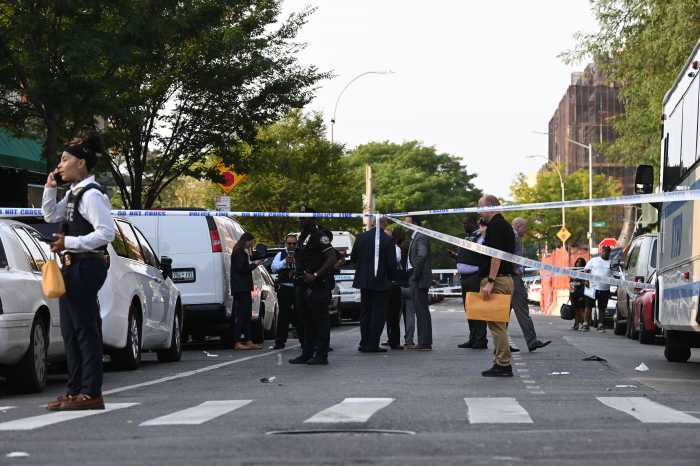 police at scene of Brooklyn mass shooting, police line stretched across roadway with cops milling about