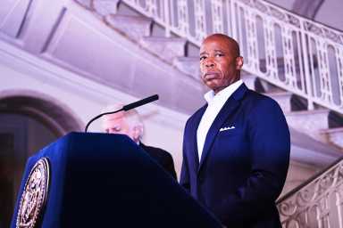 Mayor Eric Adams speaking at podium