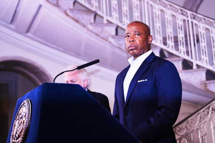 Mayor Eric Adams speaking at podium