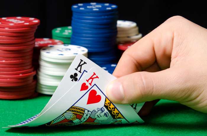 Close-up of hands with poker cards