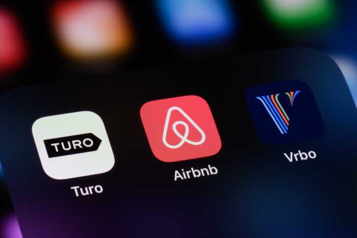 Toronto, Canada - February 23, 2025: Sharing economy apps on a smartphone: Turo, Airbnb, and Vrbo.