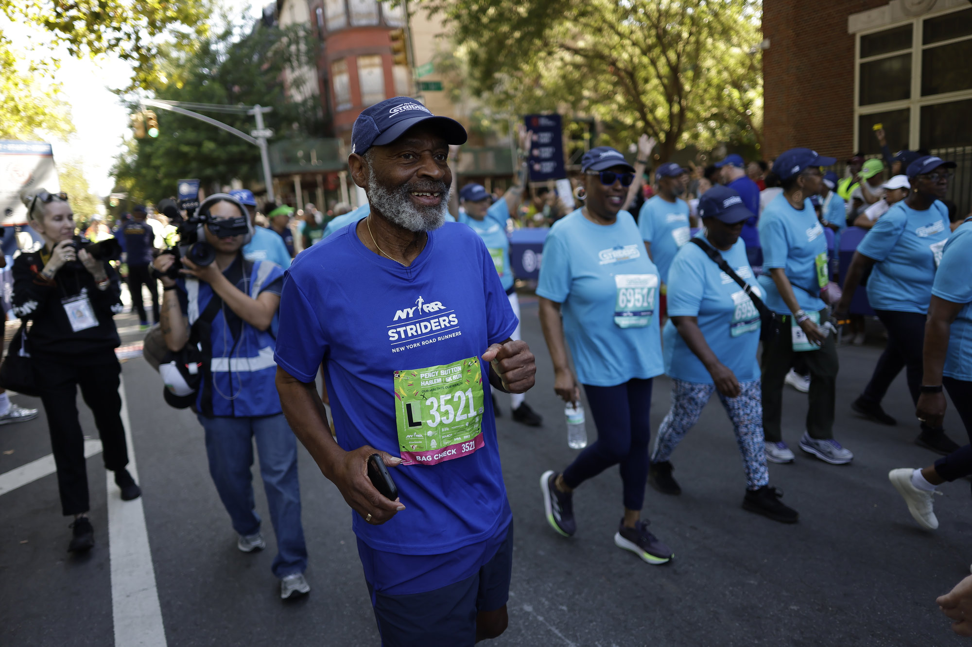 The NYRR Striders participate in the 2025 Percy Sutton Harlem 5K in Harlem, New York City. (Photo by Adam Hunger for NYRR)