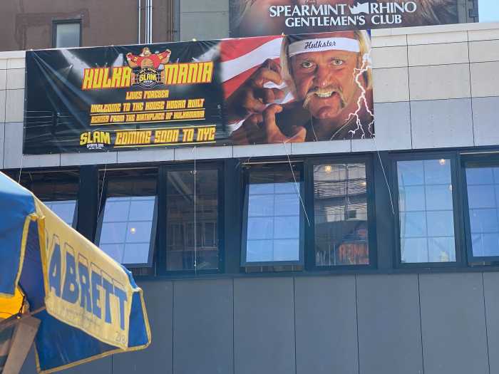 A banner featuring Hulk Hogan’s April 29, 1985, Sports Illustrated cover is displayed outside the Slam Sports Bar in Midtown. The banner will remain until permanent LED screens showcasing Hogan’s matches are installed.