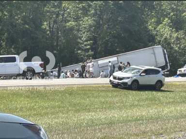 The overturned tour bus along Interstate 90 in Pembroke, N.Y., on Friday after crashing while bound for New York City.