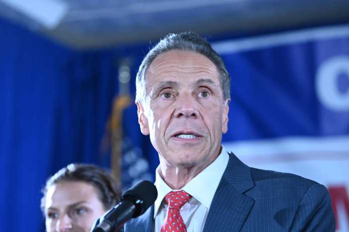 man speaking in red tie at campaign rally. Cuomo is leveraging social media to get ahead in the mayor race