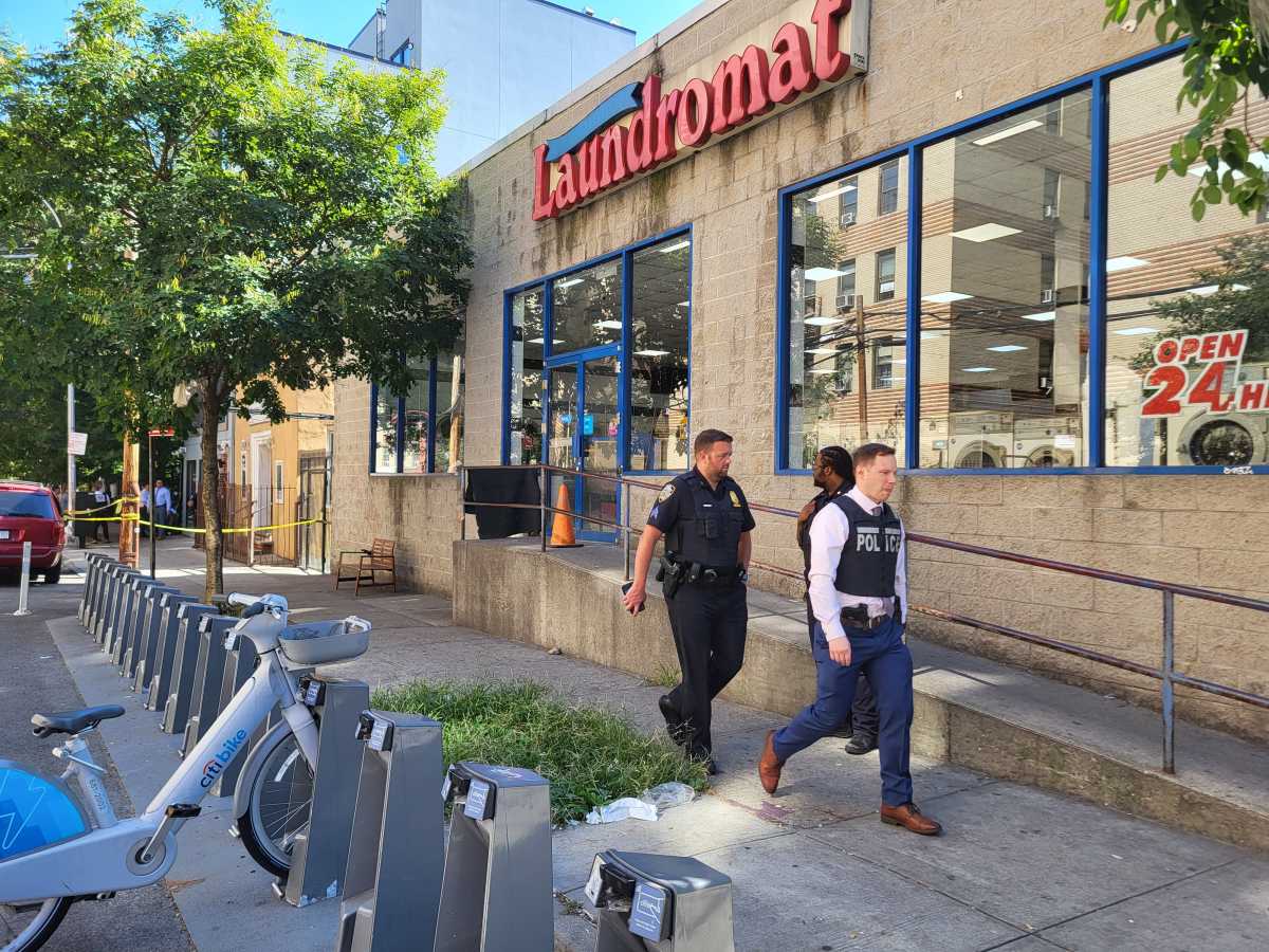 Bronx shooting rampage leaves man dead, two others wounded and suspect in custody 2 Police walk through area near shooting rampage scene in the Bronx