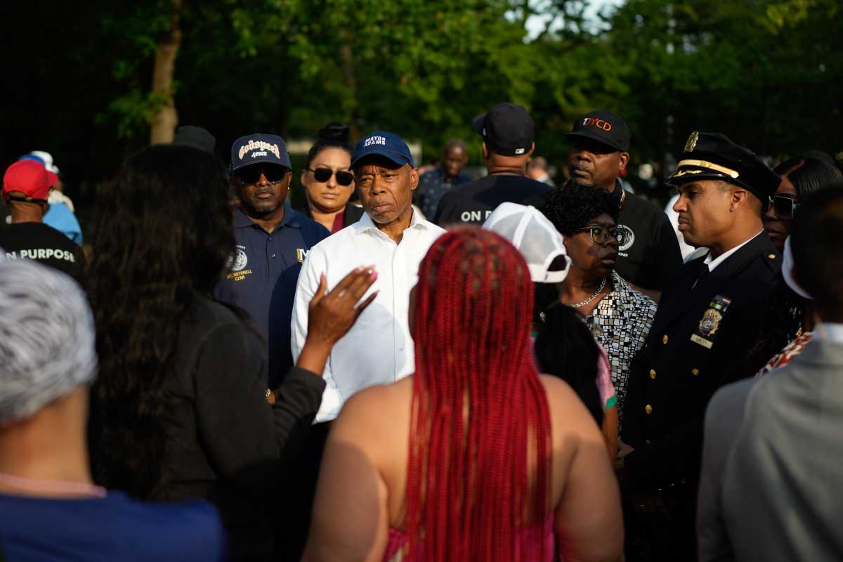 Mayor Eric Adams speaking with people in the Bronx after rash of shootings