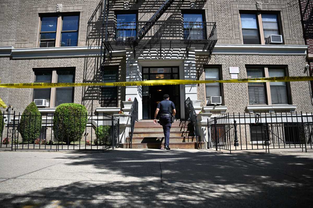 Police officer enters building in Brooklyn where shooting occurred