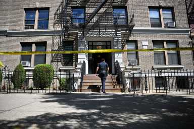 Police officer enters building in Brooklyn where shooting occurred