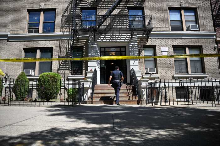 Police officer enters building in Brooklyn where shooting occurred