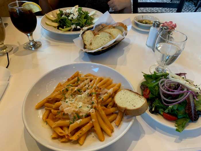 several plates of food on a table with a white tablecloth