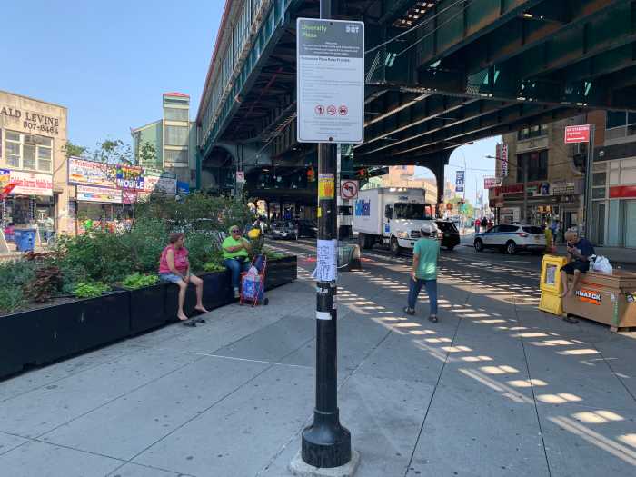 IBX Stop by Stop: Exploring the future light rail line's northern hub of Jackson Heights, a melting pot of flavors and tradition 3 people in a sprawling pedestrian space lined by streets