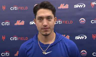 Dom Hamel Mets: Man with black hair and blue shirt stands in front of blue backdrop