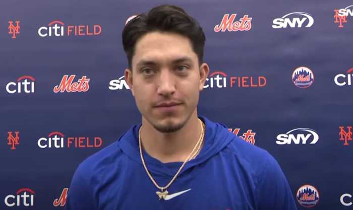 Dom Hamel Mets: Man with black hair and blue shirt stands in front of blue backdrop
