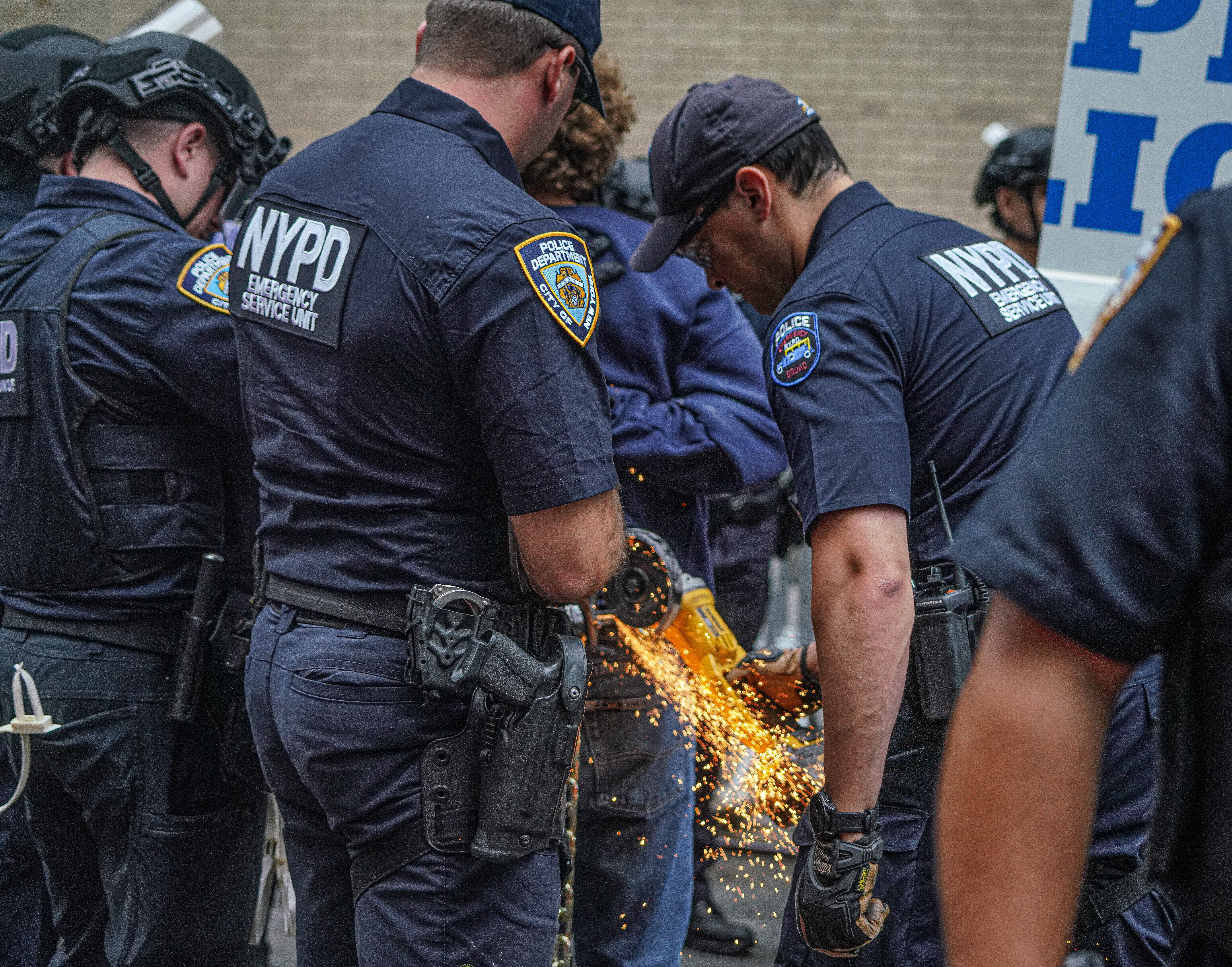 Police cut the chains of a protester in Midtown.